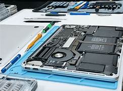 Image of a technician repairing a laptop